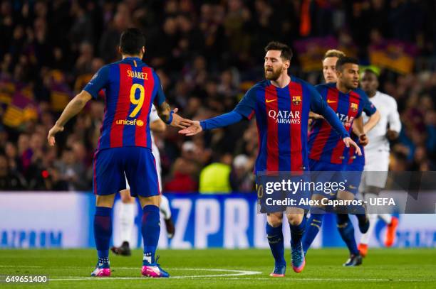 Luis Suarez of FC Barcelona celebrates with his teammate Lionel Messi after scoring the opening goal during the UEFA Champions League Round of 16...