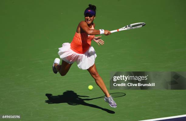 Heather Watson of Great Britain plays a forehand against Nicole Gibbs of the United States in their first round match during day three of the BNP...