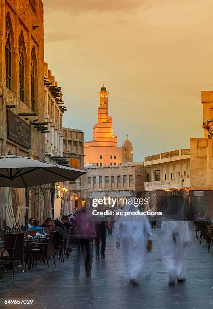 blurred view of people walking on doha street, doha, qatar - doha street stock pictures, royalty-free photos & images