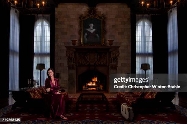 caucasian woman sitting in ornate living room - stately home interior stock pictures, royalty-free photos & images