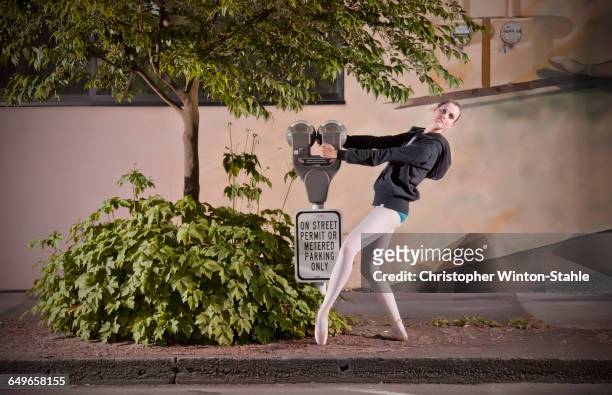 caucasian ballet dancer posing with parking meter - パーキングメーター ストックフォトと画像
