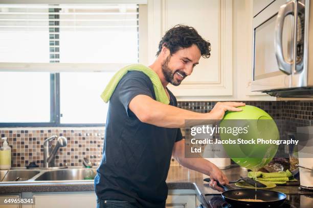 hispanic man cooking in kitchen - look down stock pictures, royalty-free photos & images