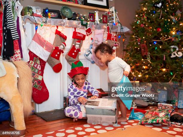 mixed race children opening christmas gifts - black stockings stock pictures, royalty-free photos & images