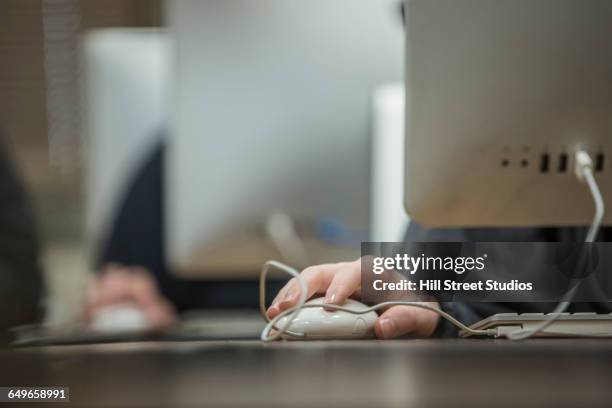 close up of student using computer mouse in classroom - school close up stock-fotos und bilder