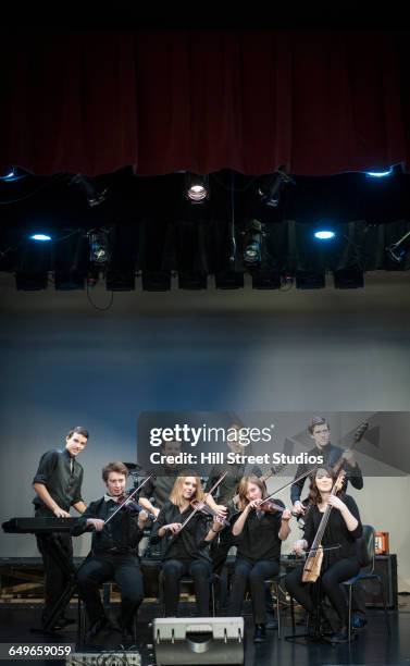 student band performing on stage - student on stage stock-fotos und bilder