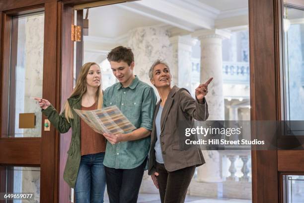 caucasian family taking tour of capitol - museum entrance stock pictures, royalty-free photos & images