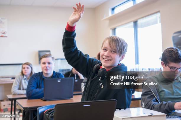 student raising hand in classroom - boy asking stock pictures, royalty-free photos & images