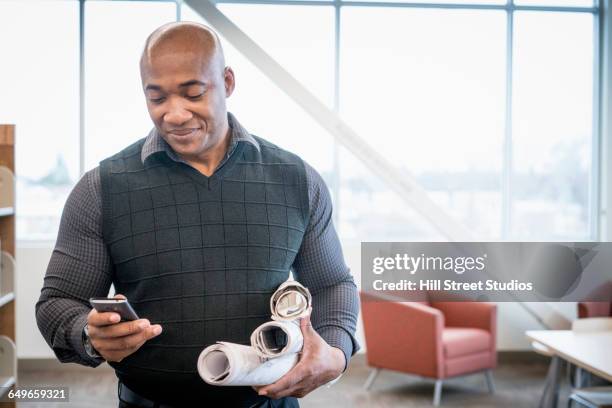 black architect using cell phone in office - roll call stock pictures, royalty-free photos & images