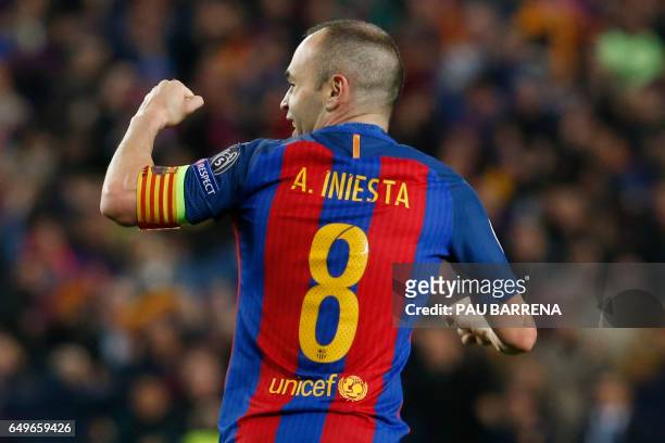 Barcelona's midfielder Andres Iniesta celebrates Paris Saint-Germain's own goal during the UEFA Champions League round of 16 second leg football...