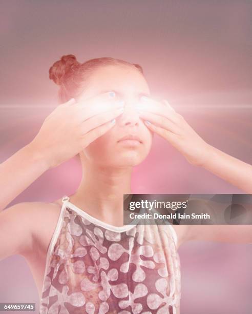 mixed race girl covering glowing eyes - mind reading stock pictures, royalty-free photos & images