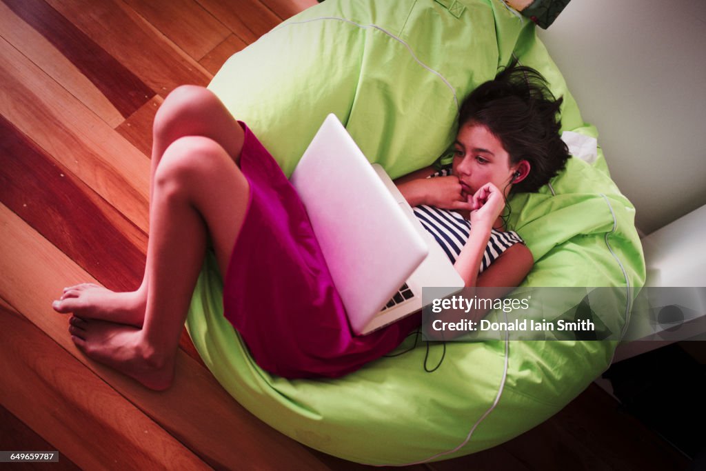 Girl using laptop in beanbag