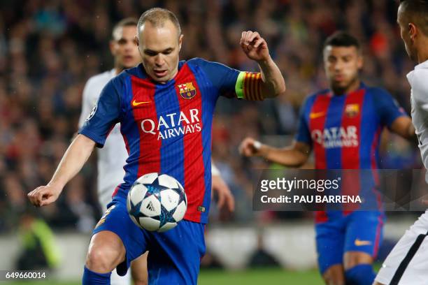 Barcelona's midfielder Andres Iniesta controls the ball during the UEFA Champions League round of 16 second leg football match FC Barcelona vs Paris...
