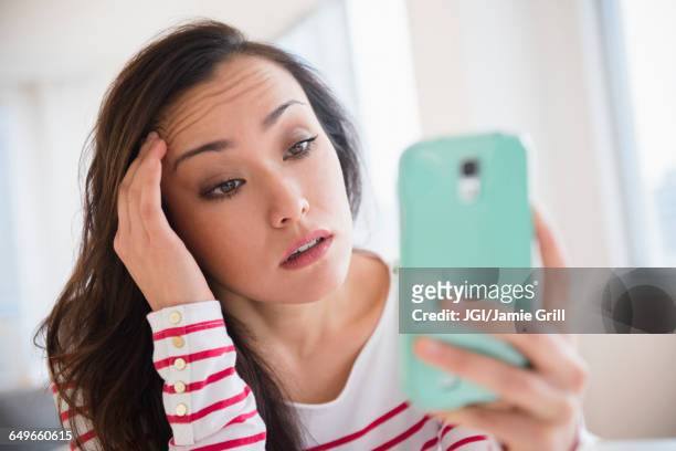 stressed woman using cell phone - frustración fotografías e imágenes de stock