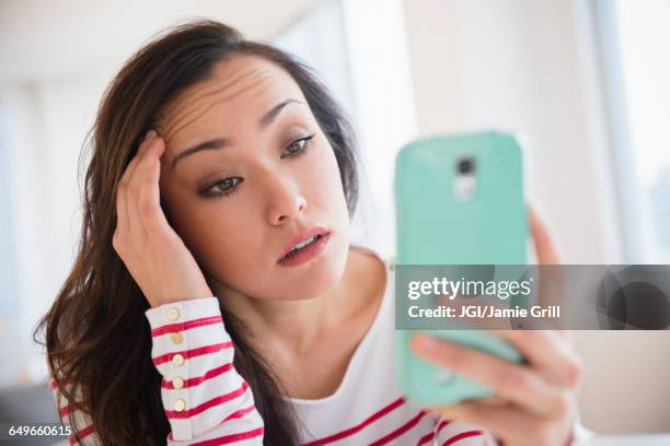 stressed woman using cell phone - technology frustration stock pictures, royalty-free photos & images