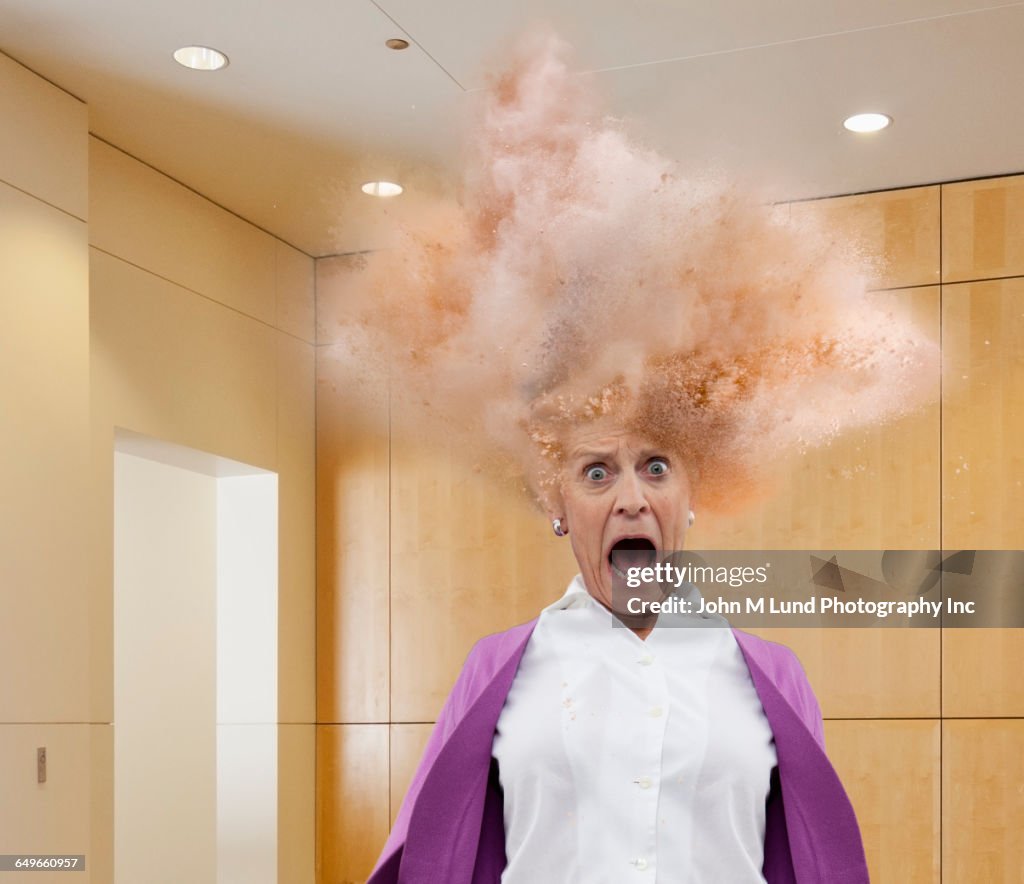 Head of Caucasian businesswoman exploding