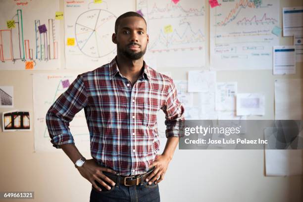 african american businessman standing in office - plaid shirt stock pictures, royalty-free photos & images