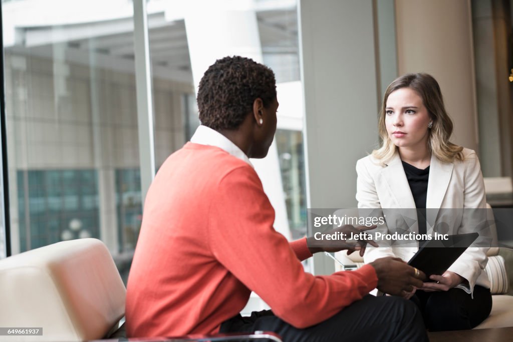 Business people using digital tablet in office