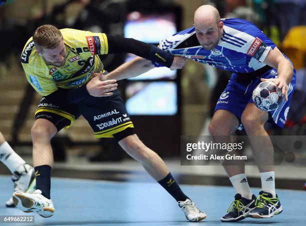 Zsolt Balogh of Szeged is challenged by Gudjon Valur Sigurdsson of Rhein-Neckar Loewen during the EHF Champions League match between Rhein Neckar...