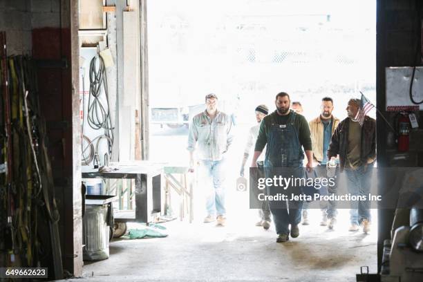 workers entering door of workshop - lunch break at work stock pictures, royalty-free photos & images