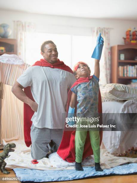 father and son playing dress-up in bedroom - the fort stock pictures, royalty-free photos & images