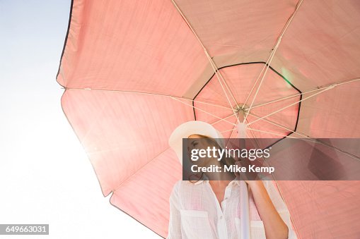 Caucasian woman holding umbrella Caucasian woman holding umbrella