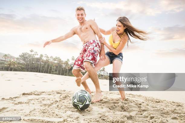 caucasian couple playing on beach - barefeet soccer stock pictures, royalty-free photos & images