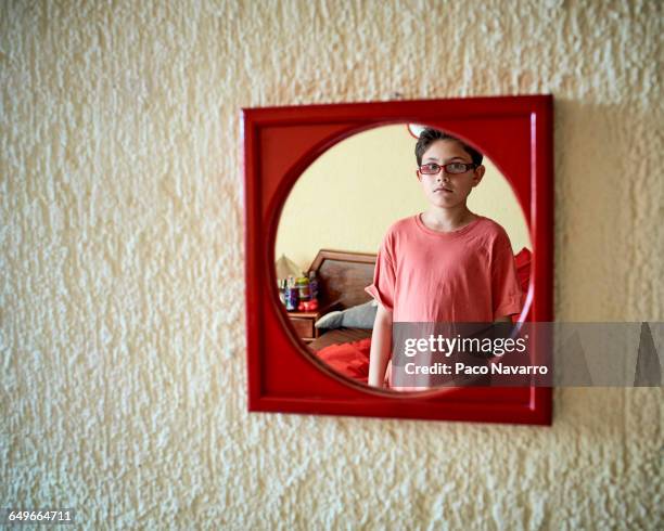 hispanic boy admiring himself in mirror - zapopan stock pictures, royalty-free photos & images