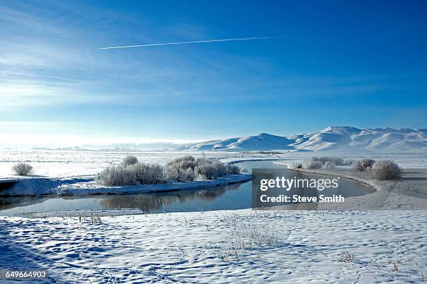 snowy mountains and river in remote landscape - ketchum idaho stock pictures, royalty-free photos & images