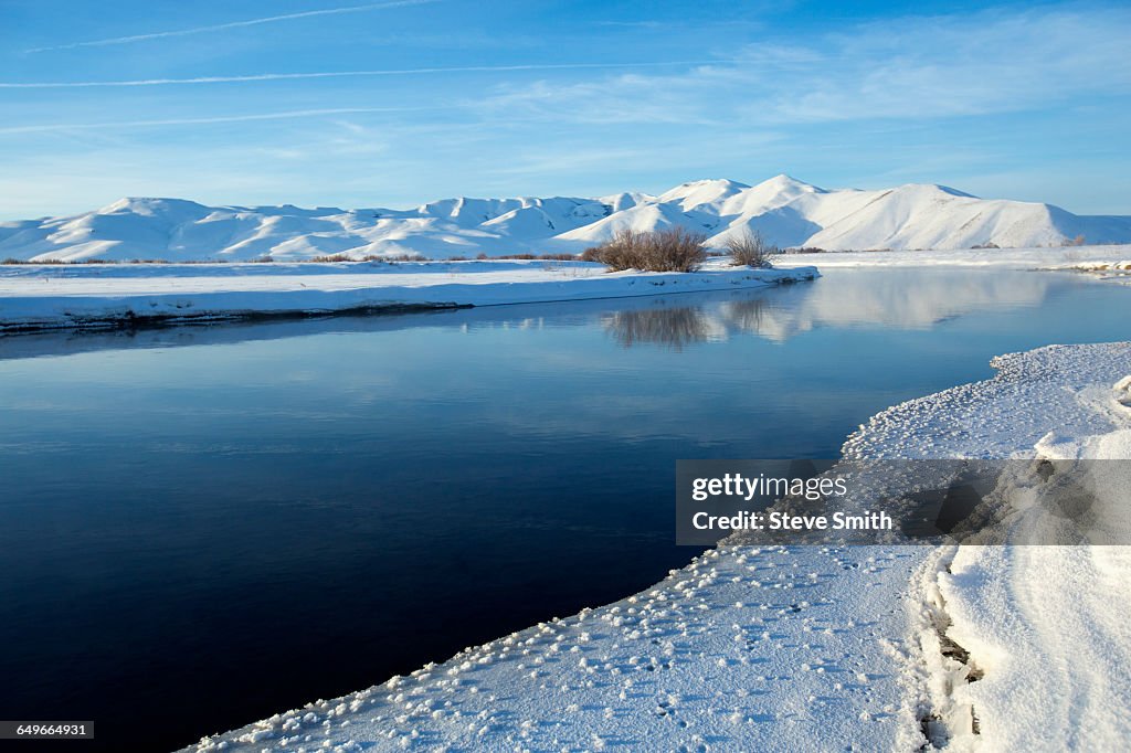 Still river in snowy remote landscape