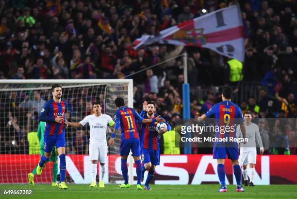 Lionel Messi of Barcelona (10 celebrates as he scores their third goal from a penalty with Neymar during the UEFA Champions League Round of 16 second...