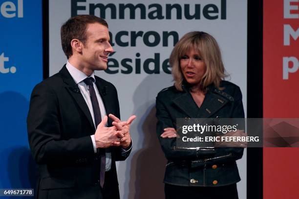 French presidential election candidate for the En Marche movement Emmanuel Macron and his wife Brigitte Trogneux attend an event organised by the...