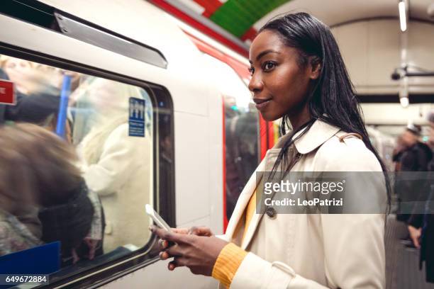 woman taking the subway train - london tube stock pictures, royalty-free photos & images
