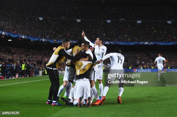 Edinson Cavani of Edinson Cavani of PSG celebrates with team mates as he scores their first goal during the UEFA Champions League Round of 16 second...