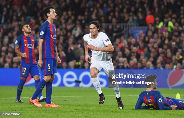 Barcelona players look dejected as Edinson Cavani of Edinson Cavani of PSG celebrates as he scores their first goal during the UEFA Champions League...