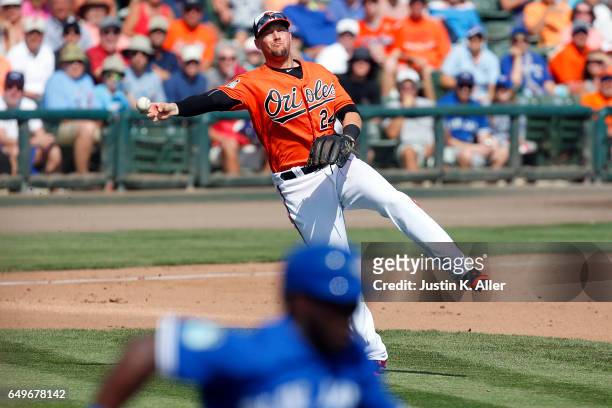 Chris Johnson of the Baltimore Orioles makes a throw against the Toronto Blue Jays in a spring training game on March 8, 2017 at Ed Smith Stadium in...