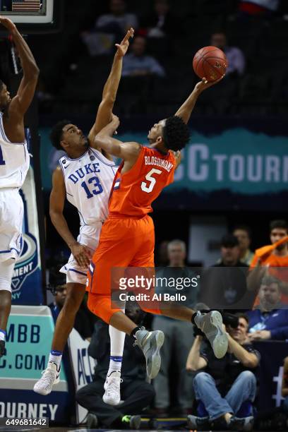 Jaron Blossomgame of the Clemson Tigers shoots against Matt Jones of the Duke Blue Devils during the second round of the ACC Basketball Tournament at...