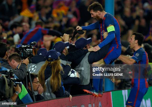Barcelona's Argentinian forward Lionel Messi and Barcelona's midfielder Sergio Busquets celebrate their victory at the end of the UEFA Champions...