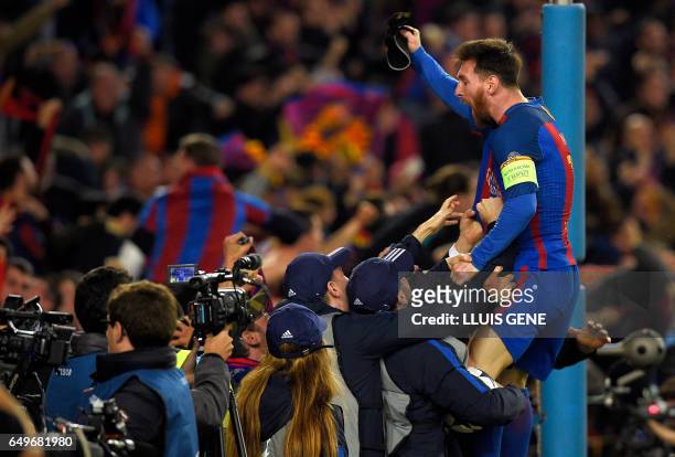 Barcelona's Argentinian forward Lionel Messi celebrates their victory at the end of the UEFA Champions League round of 16 second leg football match...