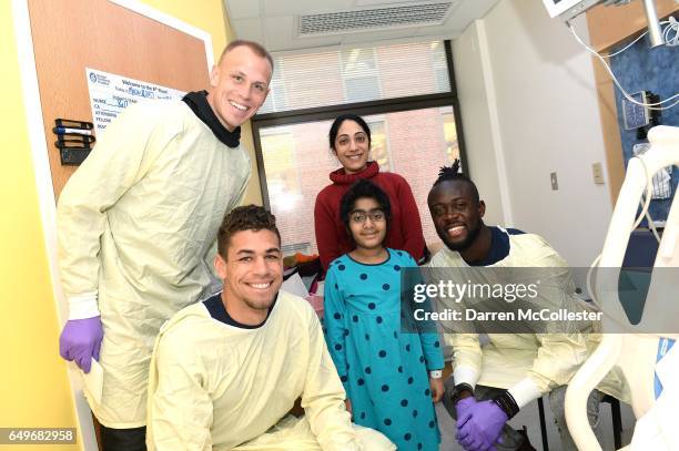 New England Revolution's Cody Cropper, Joshua Smith, and Kei Kamara visit Vai and Mom at Boston Children's Hospital on March 8, 2017 in Boston,...