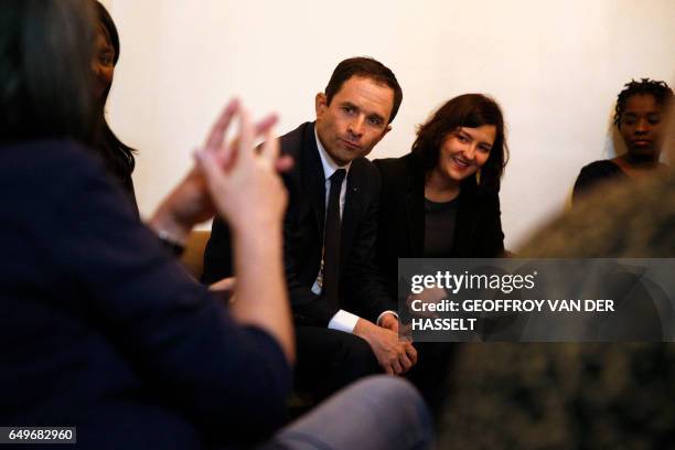 French presidential election candidate for the left-wing French Socialist party Benoit Hamon talks with women during a visit to a shelter for abused...