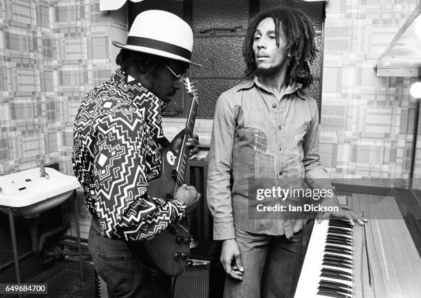 Aston 'Family Man' Barrett and Bob Marley of The Wailers playing guitar and keyboards backstage at the Odeon, Birmingham, United Kingdom, 18 July...