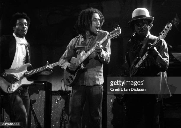 Al Anderson, Bob Marley and Aston 'Family Man' Barrett of The Wailers perform on stage at the Odeon, Birmingham, United Kingdom, 18 July 1975.