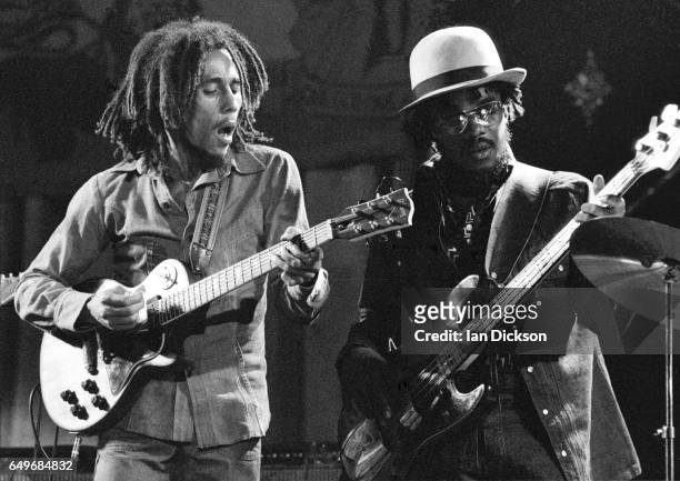 Bob Marley and Aston 'Family Man' Barrett of The Wailers perform on stage at the Odeon, Birmingham, United Kingdom, 18 July 1975.