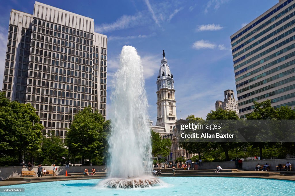 John F Kennedy plaza against blue skies with fountain