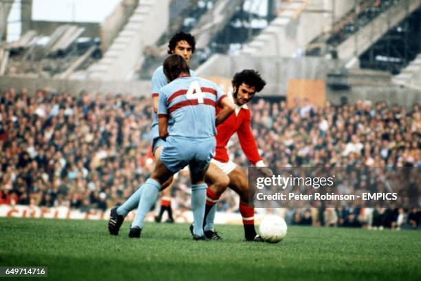 George Best of Manchester United takes on West Ham United's Billy Bonds and Trevor Brooking