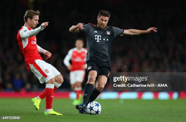 Nacho Monreal of Arsenal and Xabi Alonso of Bayern Munich during the UEFA Champions League Round of 16 second leg match between Arsenal FC and FC...
