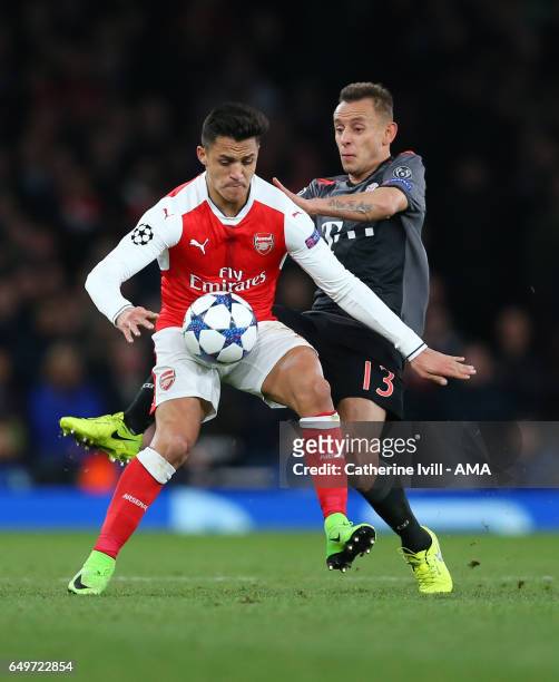 Alexis Sanchez of Arsenal and Rafinha of Bayern Munich during the UEFA Champions League Round of 16 second leg match between Arsenal FC and FC Bayern...