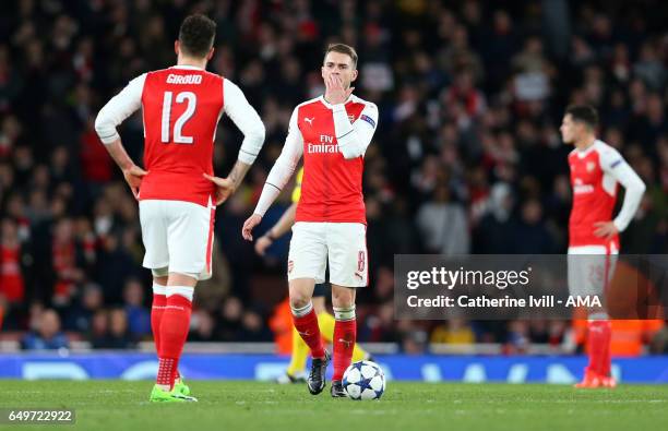 Aaron Ramsey of Arsenal stands dejected with Olivier Giroud of Arsenal during the UEFA Champions League Round of 16 second leg match between Arsenal...