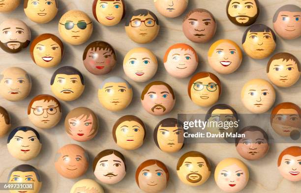wooden balls with multi-ethnic faces on them. (top view) - global village stock pictures, royalty-free photos & images