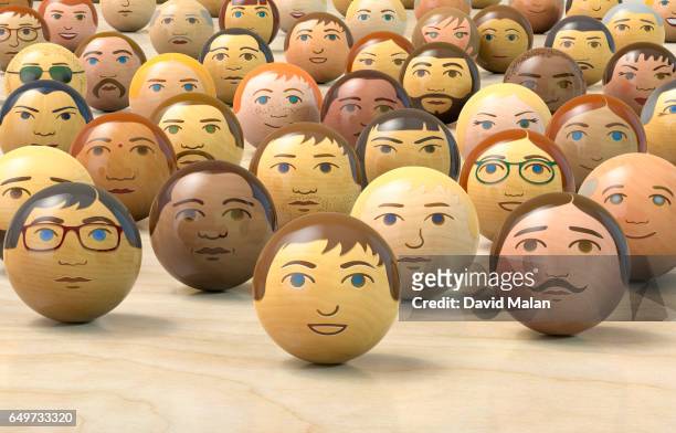 wooden balls with multi-ethnic faces on them. (low angle view) - antropomorfo foto e immagini stock